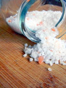 pink and white salt spilling out of a jar