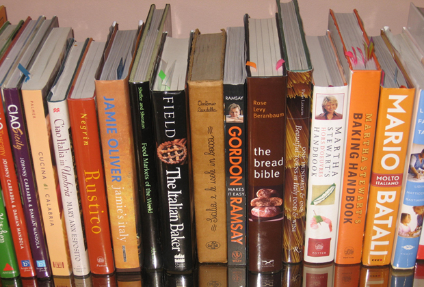 A shelf crammed with cookbooks
