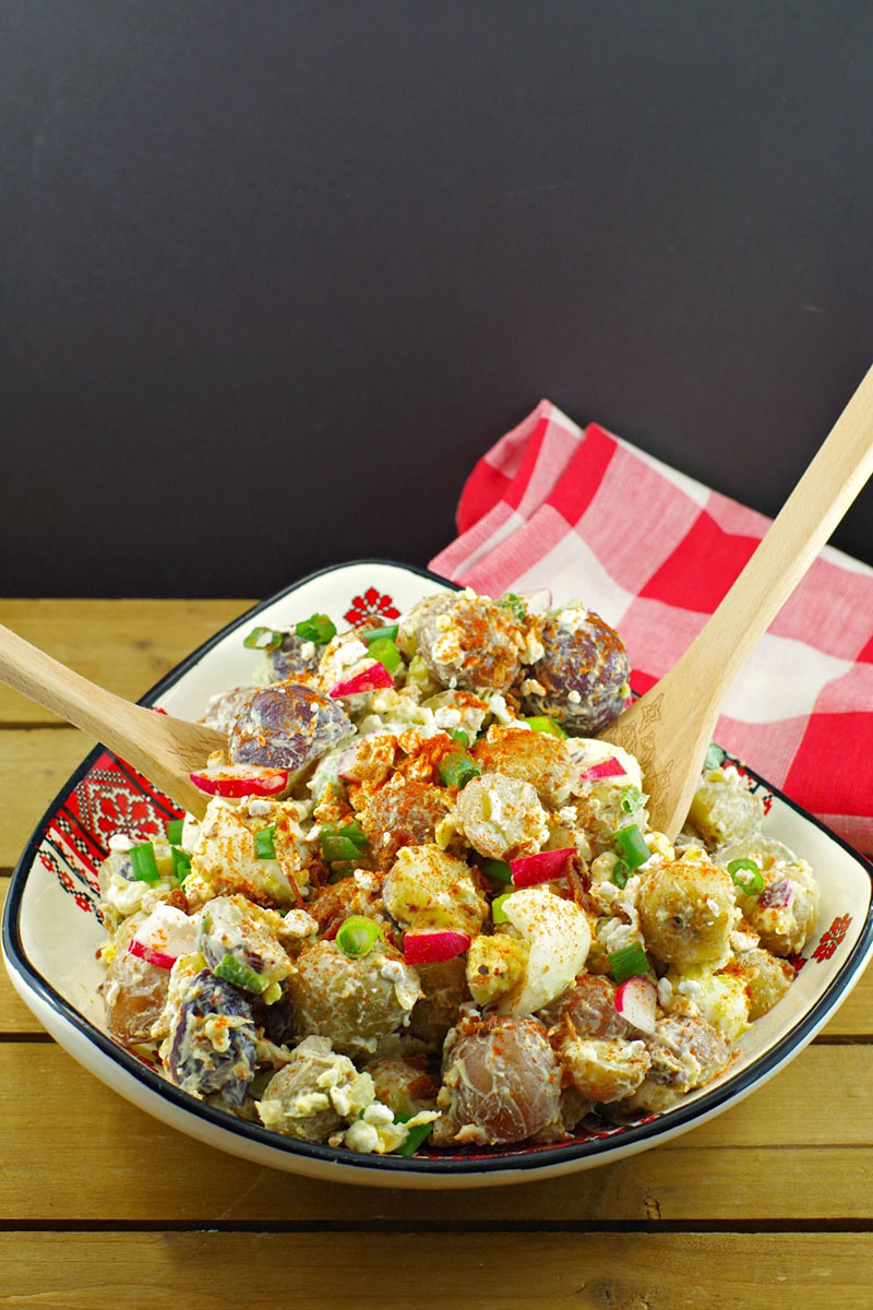 Perogy Potato Salad in a bold with serving tongs