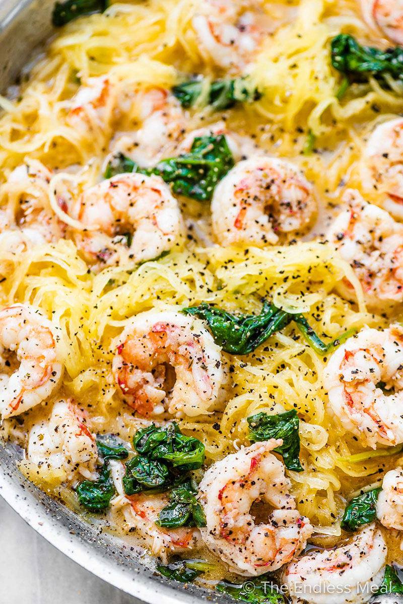 A dish of spaghetti squash noodles with peppered shrimp