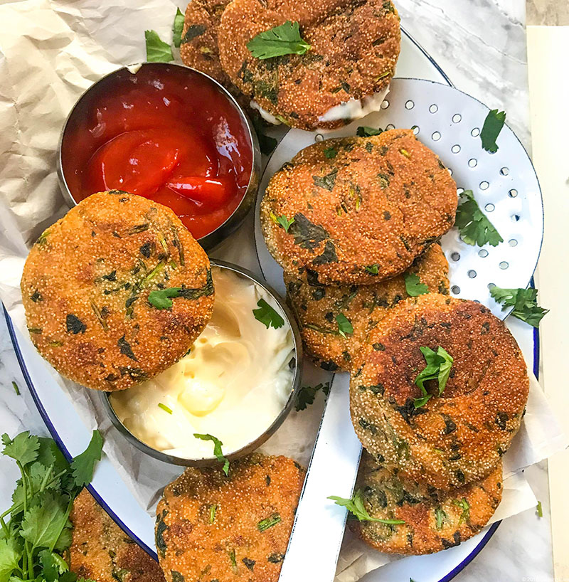 A plate of cilantro fritters with dips