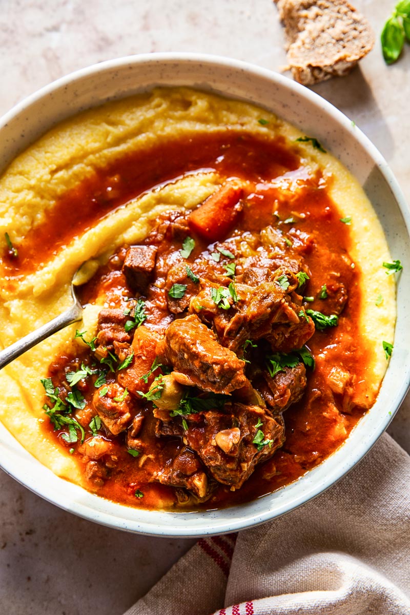 A bowl of polenta topped with Italian beef stew