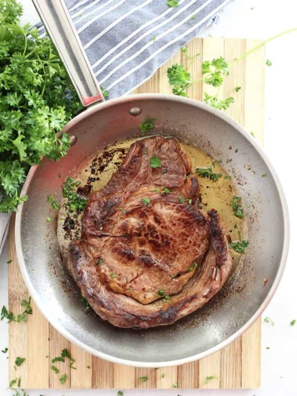 Beer Marinated Steak on a pan with fresh herbs