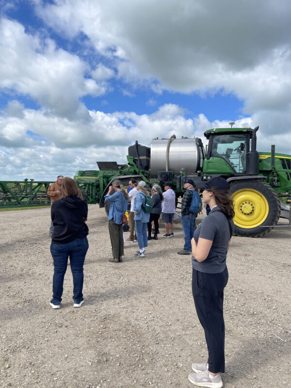 People in front of a tractor.